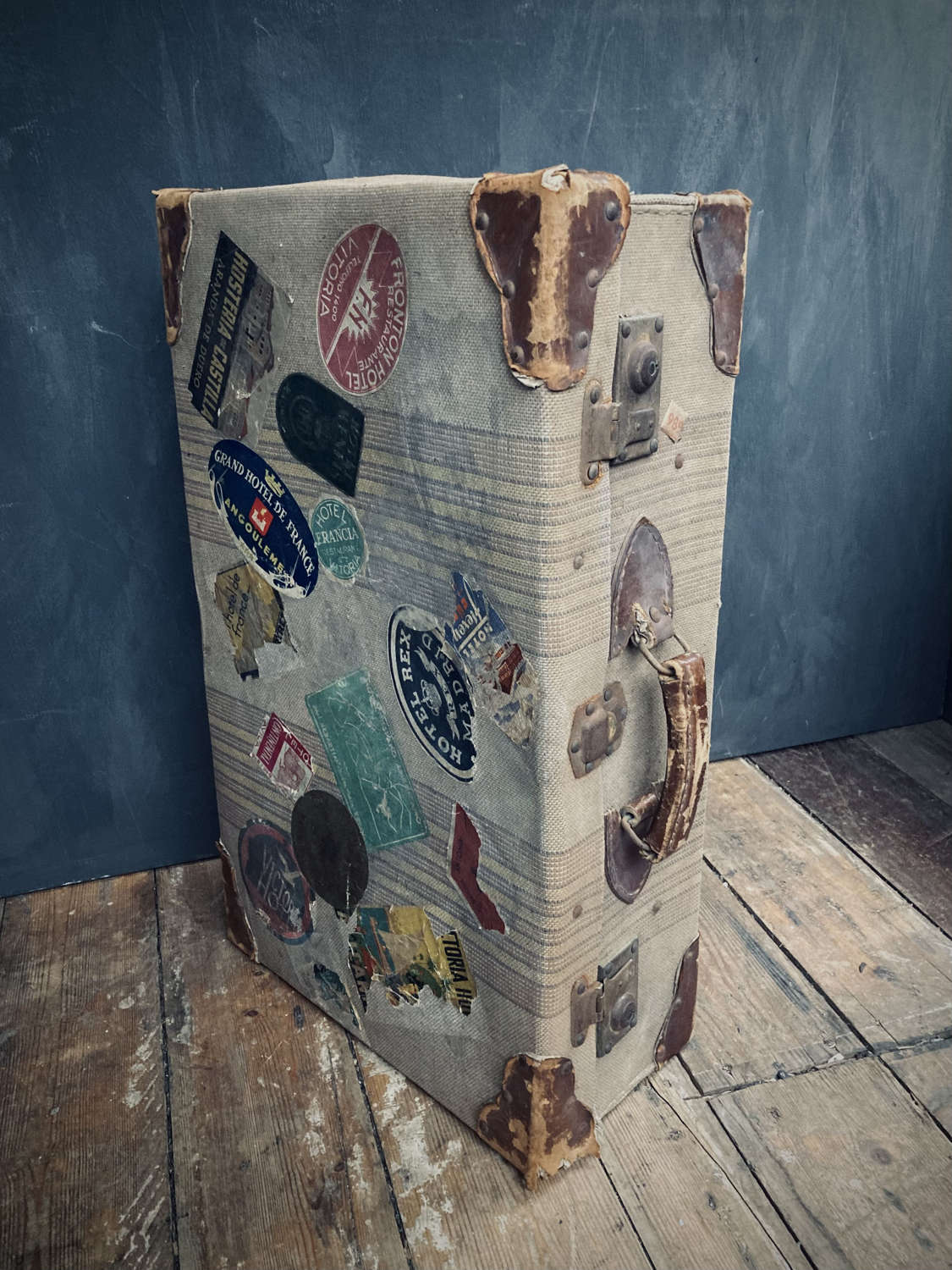 A travel suitcase with destination stickers.